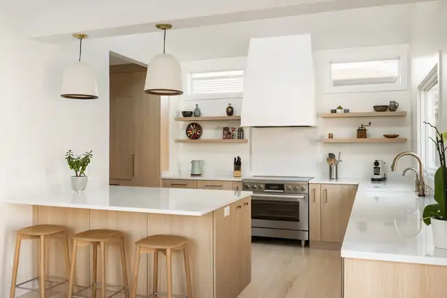 Kenwood Scandinavian kitchen with light wood cabinets, white plaster-look hood and open floating shelves