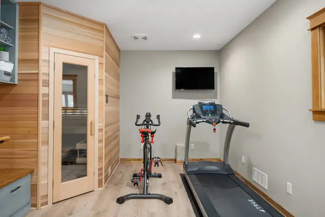 Finished basement home gym with a cedar infrared sauna, treadmill and exercise bike in a St. Paul area home