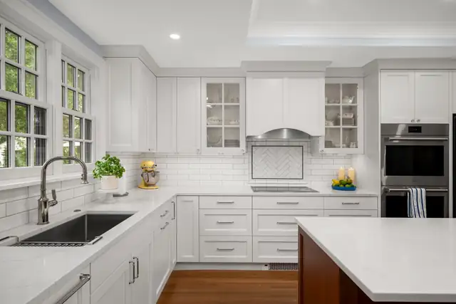 Montcalm whole-home kitchen remodel in St. Paul with white cabinets, glass-front uppers, subway tile and a cherry island